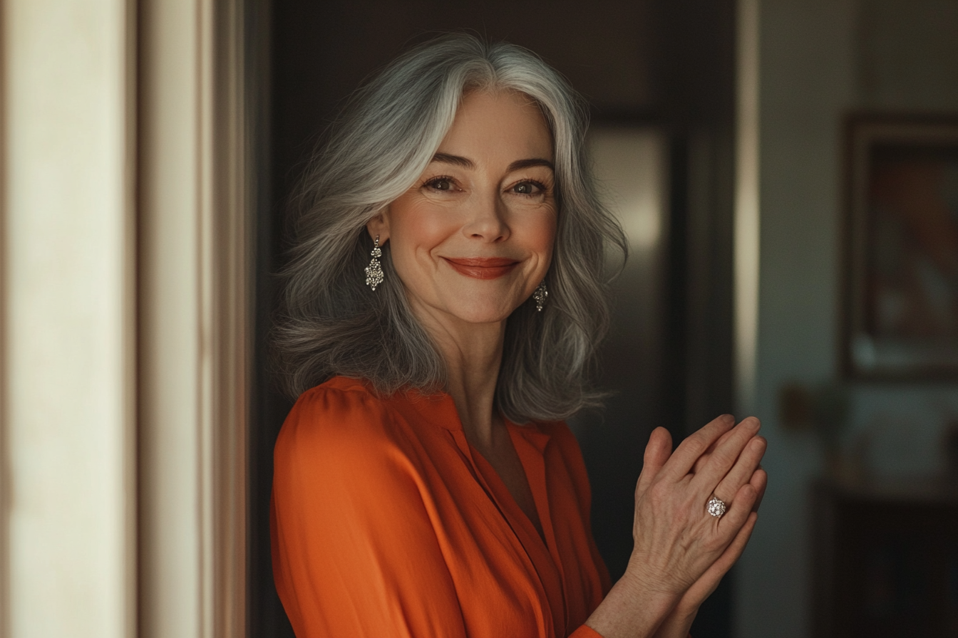 A woman smiling while standing at a doorway with her hands clasped | Source: Midjourney