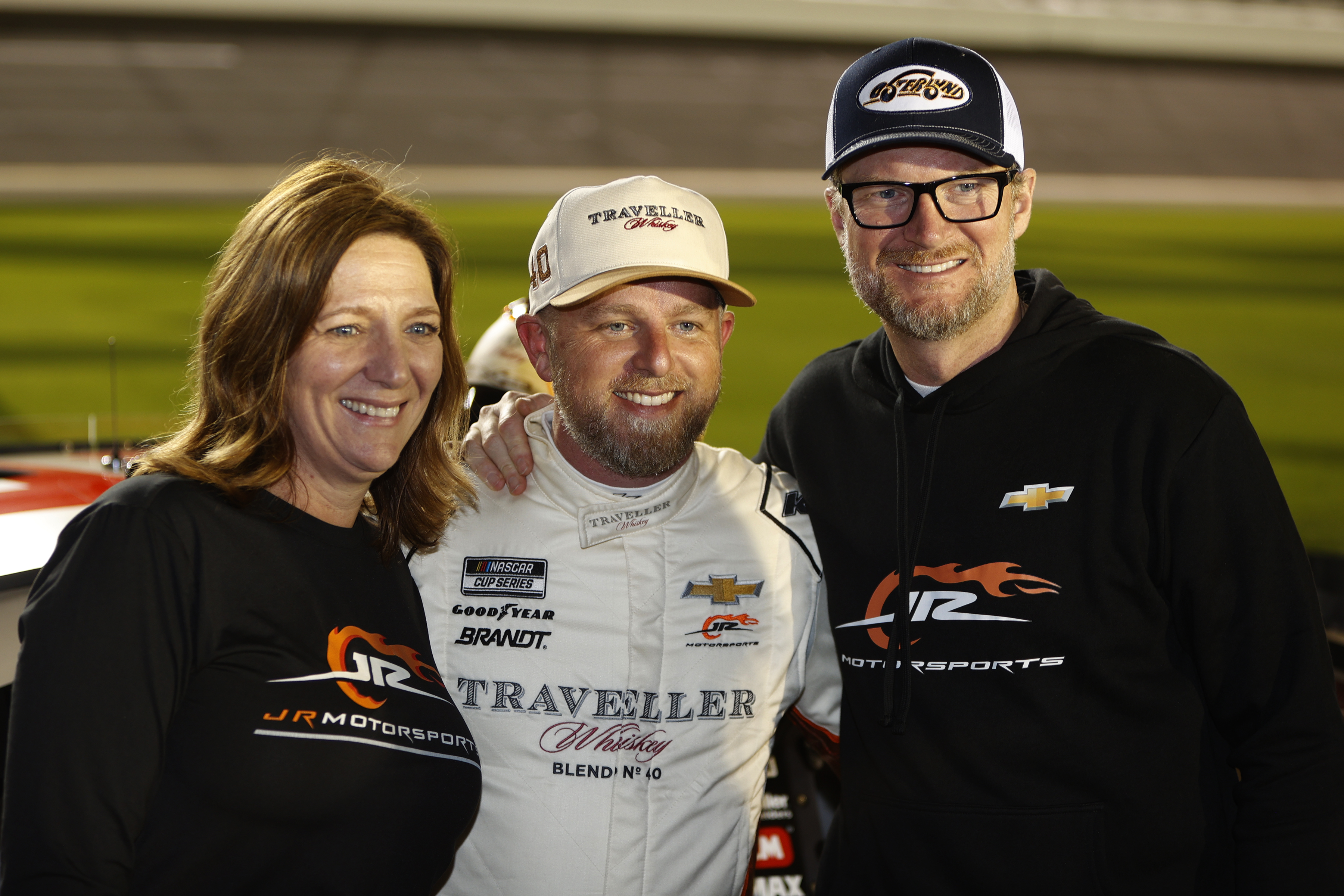 Kelley Earnhardt Miller takes a picture with racer Justin Allgaier, and her brother Dale Earnhardt Jr. on February 12, 2025 | Source: Getty Images