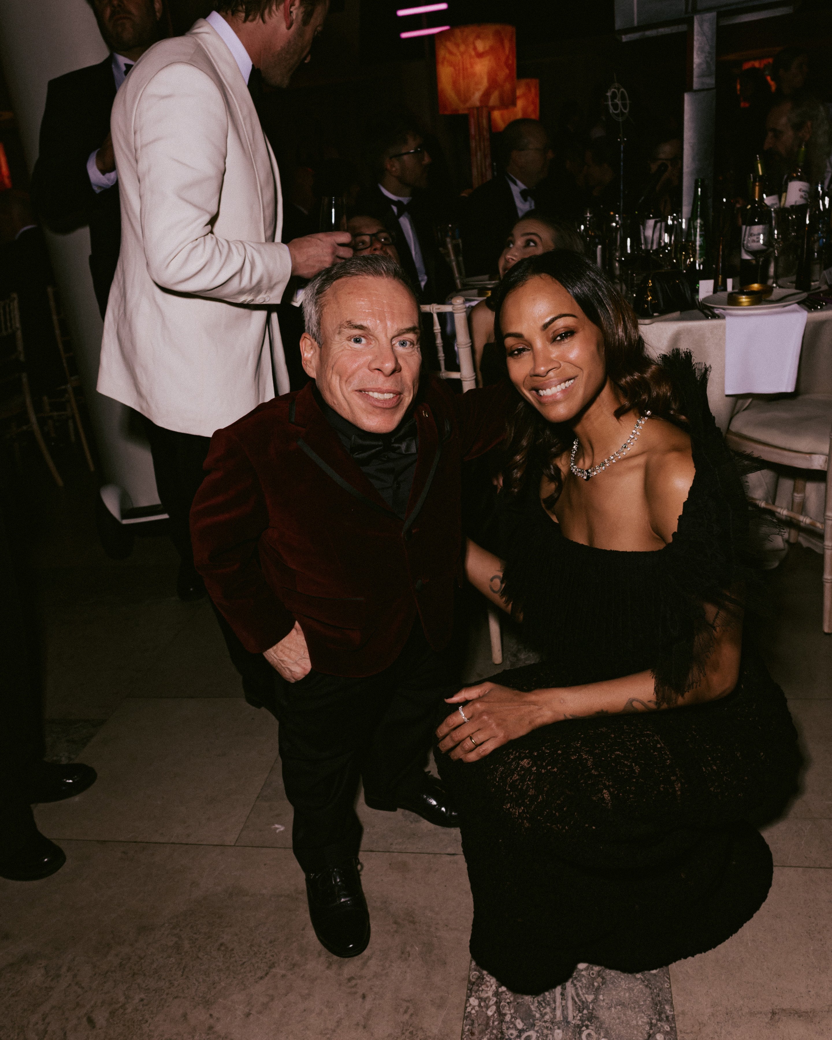 Warwick Davis and Zoe Saldana attend the EE BAFTA Film Awards Dinner 2025 on February 16, 2025 | Source: Getty Images