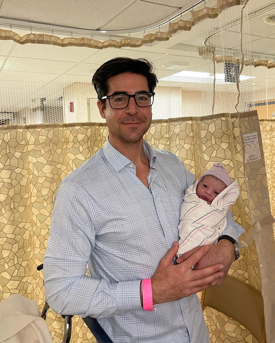 Jesse Watters holding his newborn daughter Georgina (GiGi) Post Watters