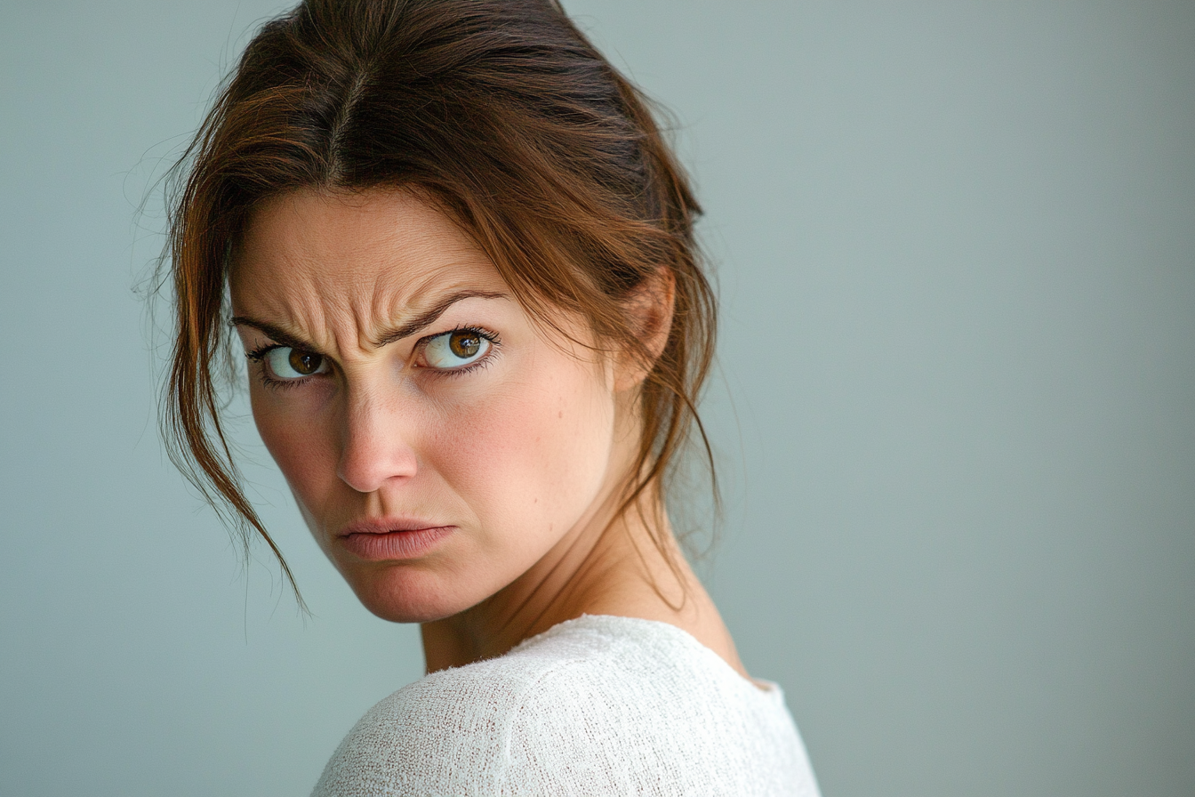 A frowning woman looking over her shoulder | Source: Midjourney