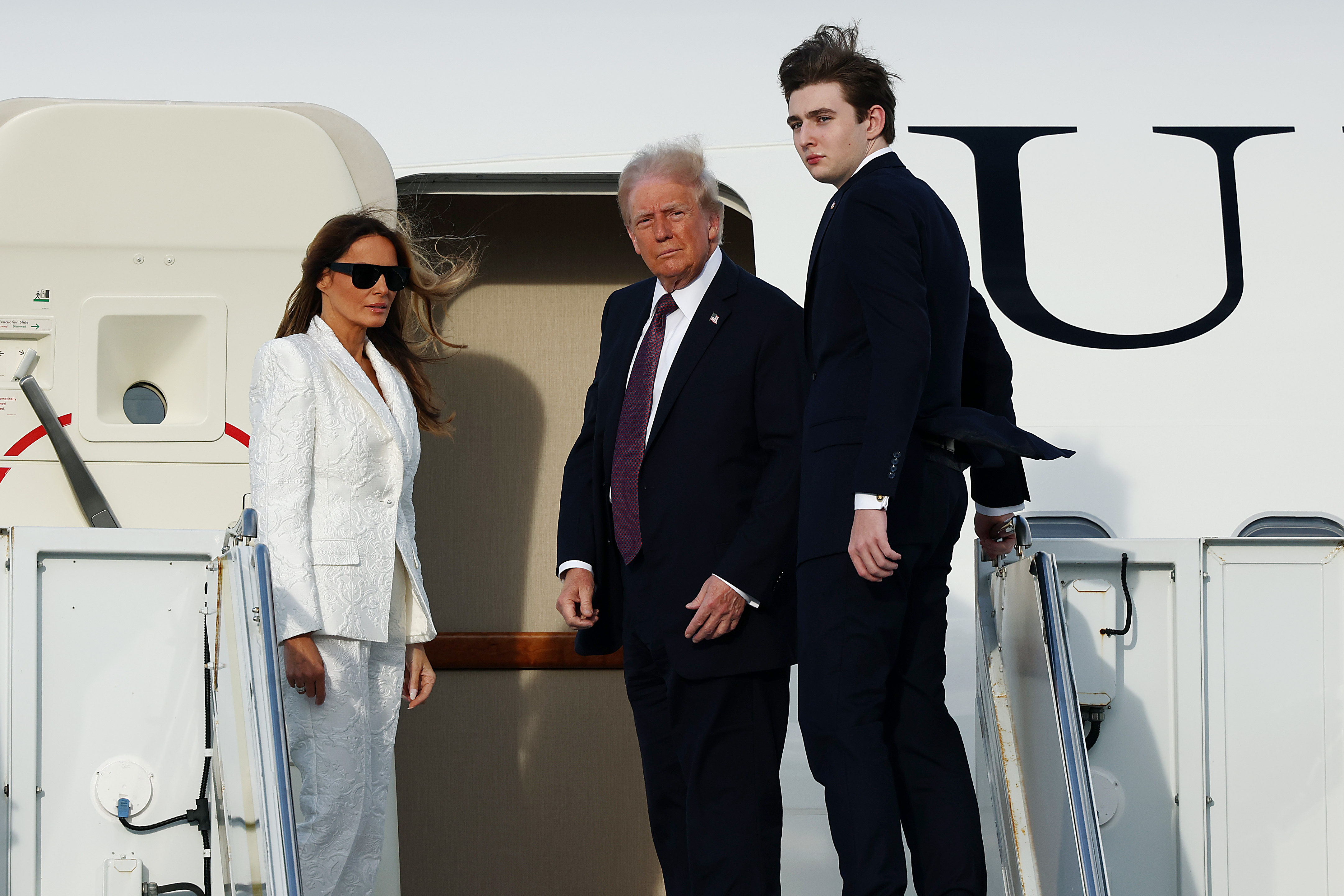 Melania, Donald, and Barron Trump photographed on January 18, 2025, in West Palm Beach, Florida. | Source: Getty Images