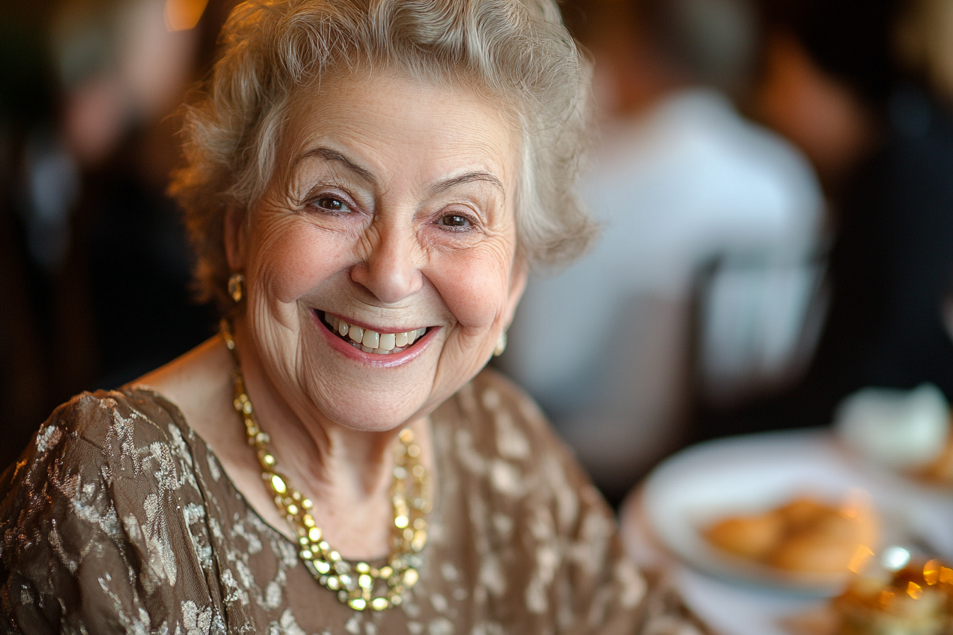 An elderly woman in a restaurant smiling at someone | Source: Midjourney