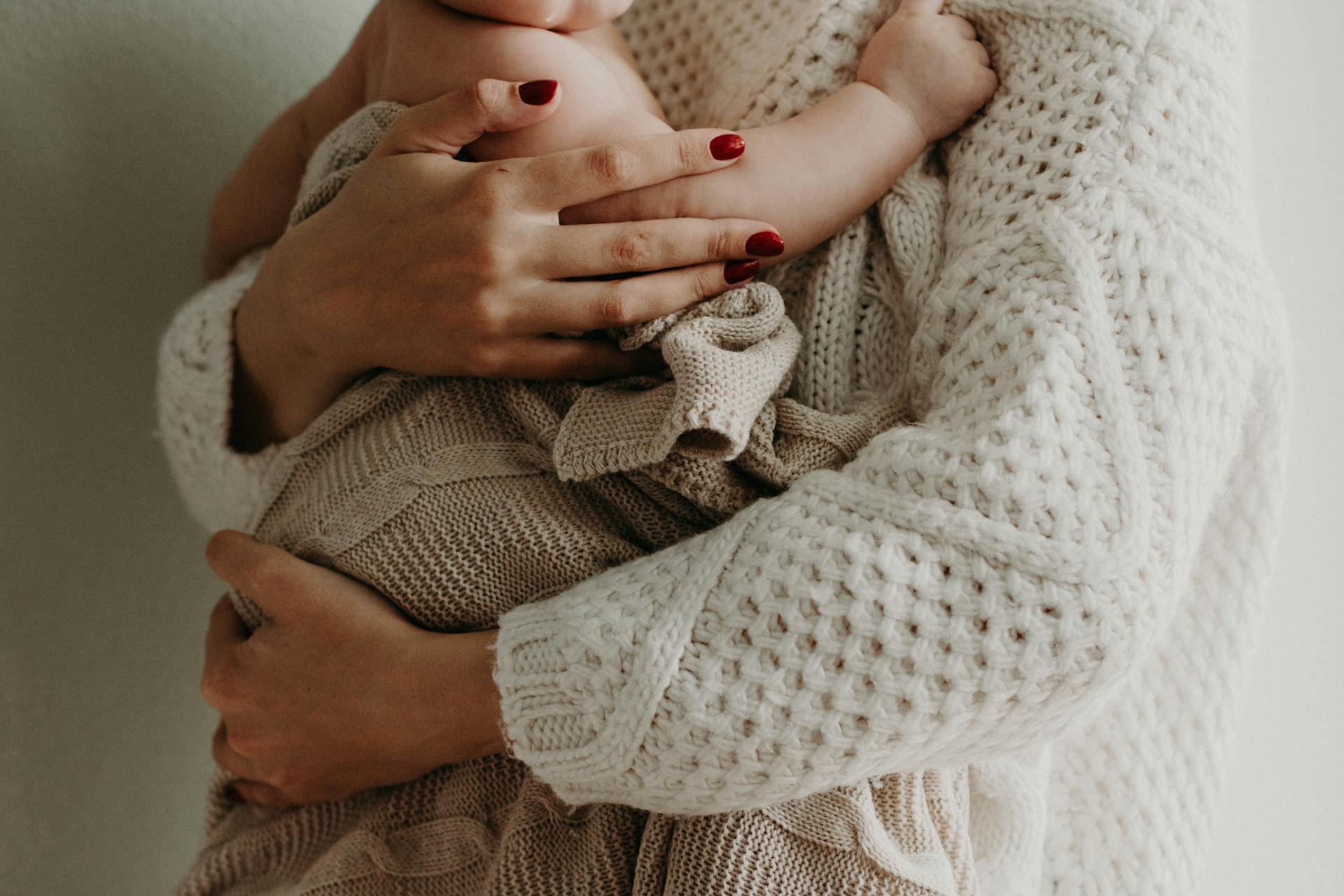 Cropped shot of a woman holding a baby | Source: Pexels