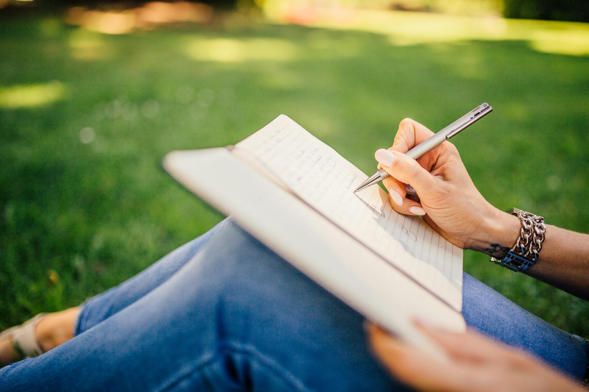 A woman writing in her notebook | Source: Pexels