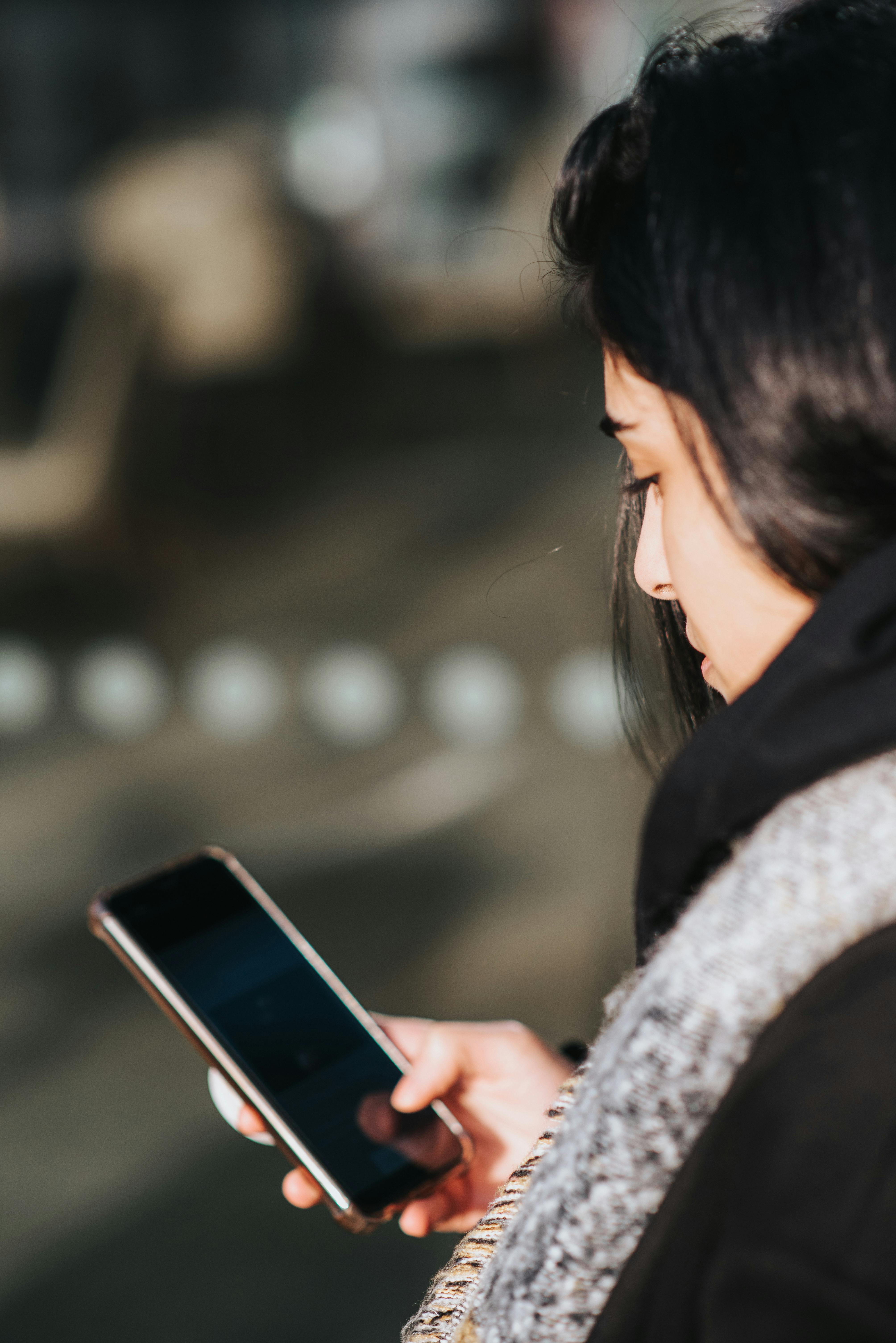 Woman watching her phone intently | Source: Pexels